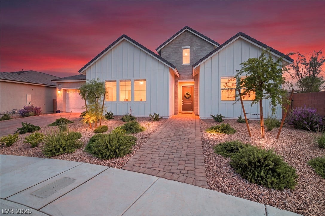 5745 N Golden Chase Court, Las Vegas, NV 89131 Board and batten siding pairs with stone accents to create a striking modern facade.