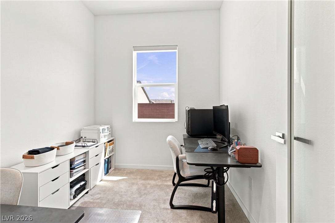 5745 N Golden Chase Court, Las Vegas, NV 89131 Plush carpeting and crisp walls define this quiet office space featuring a bright window.