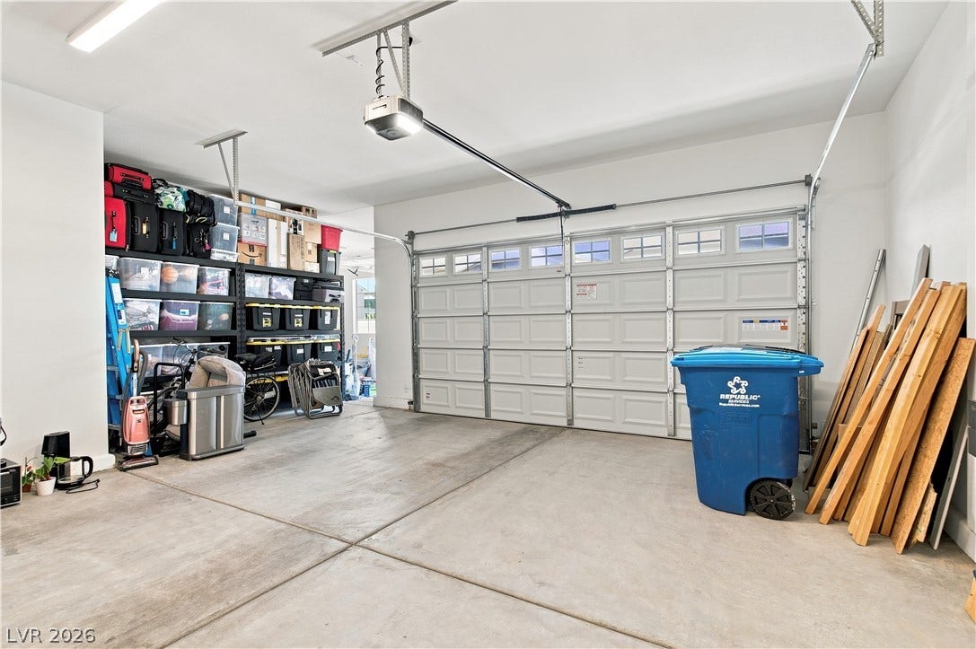 5745 N Golden Chase Court, Las Vegas, NV 89131 A spacious garage features durable concrete flooring and high ceilings.