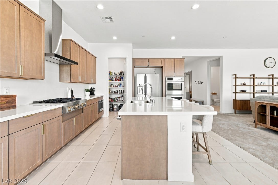 5745 N Golden Chase Court, Las Vegas, NV 89131 An open floorplan seamlessly connects the contemporary kitchen to the main living area.