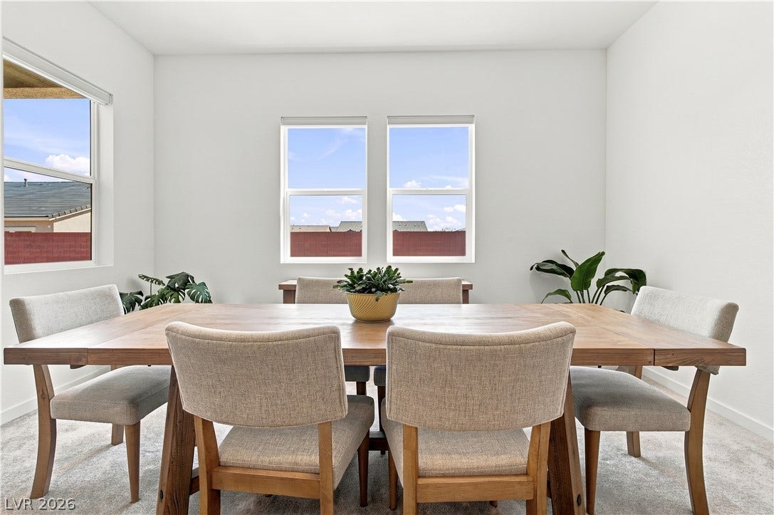 5745 N Golden Chase Court, Las Vegas, NV 89131 Sunlight streams through multiple windows into this spacious carpeted dining space.