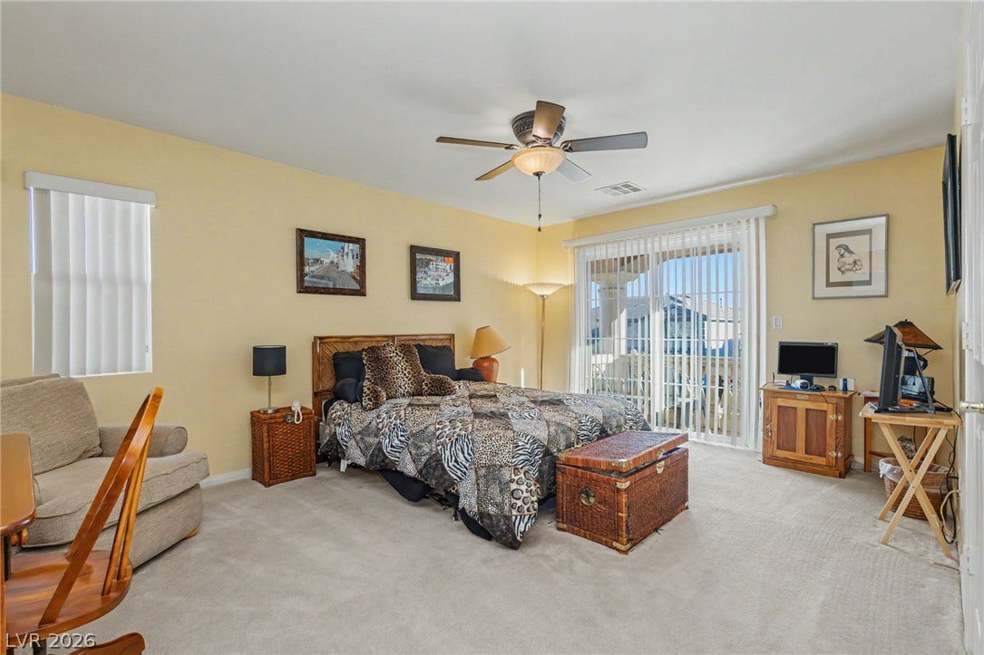 Sliding glass doors open directly to a private balcony from this spacious bedroom.