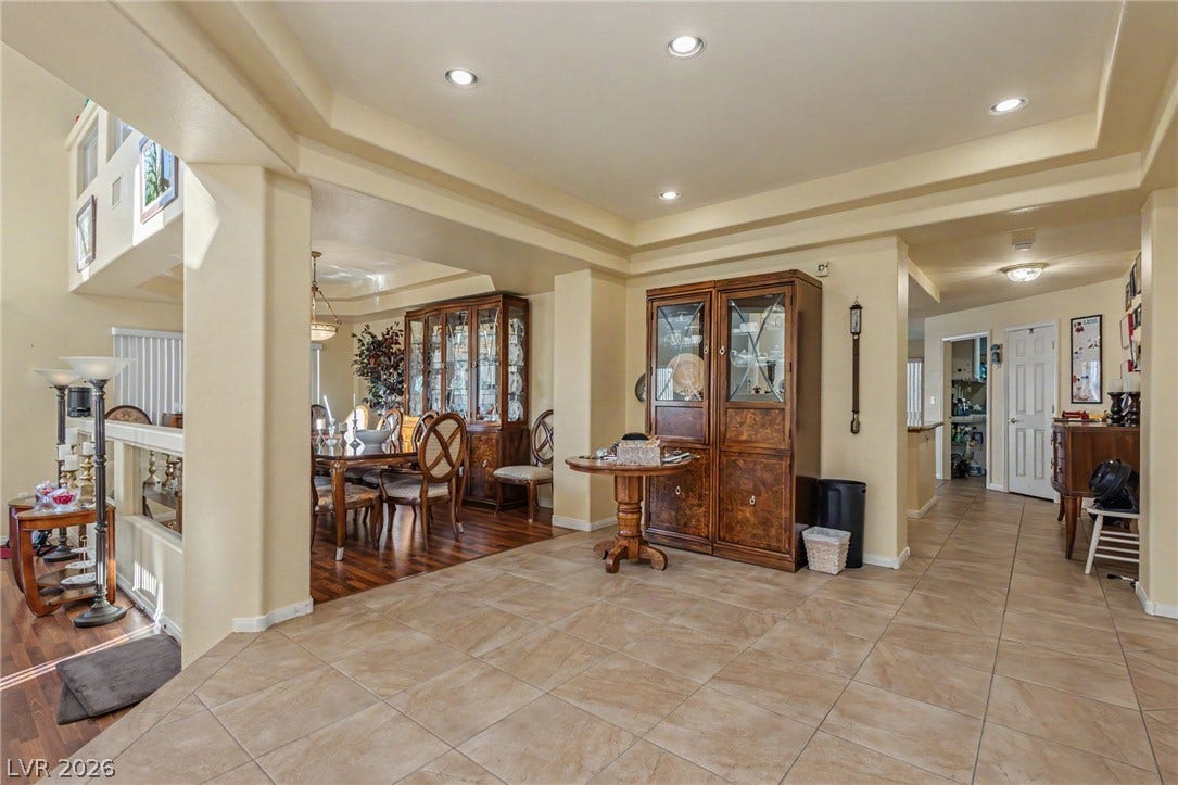 Inlaid tile flooring and recessed lighting define this spacious transitional entryway and dining transition.