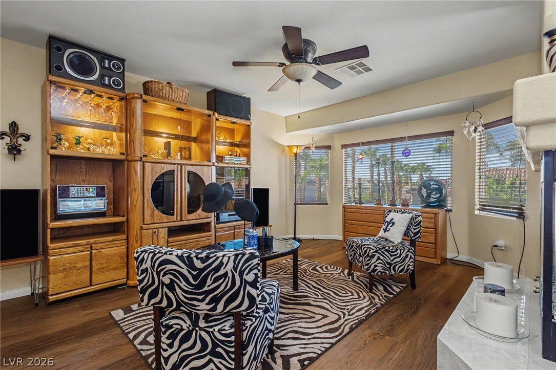 Gleaming hardwood floors and a bright bay window wall define this inviting living area.