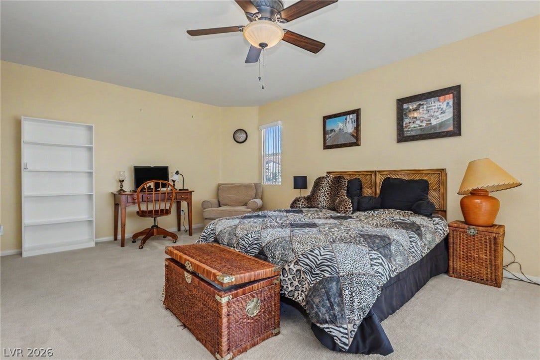 Plentiful natural light and soft carpeting create a comfortable atmosphere in this bedroom.