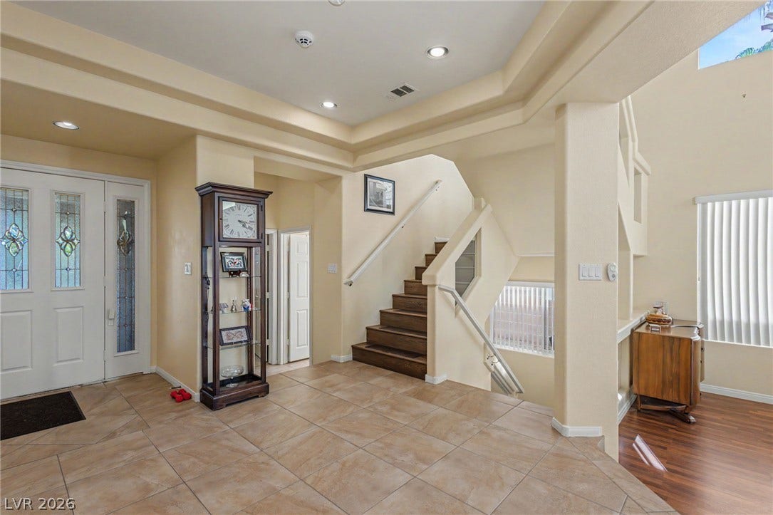Tiled floors and a recessed ceiling enhance this welcoming entryway.