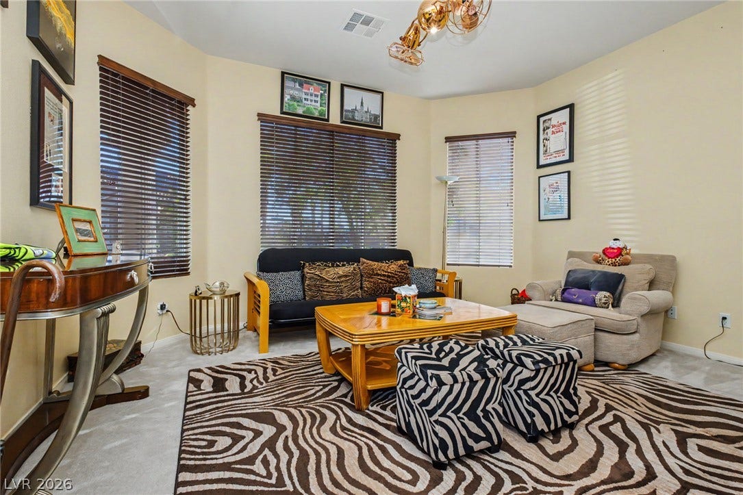 High ceilings and generous windows filter natural light across this versatile living space.