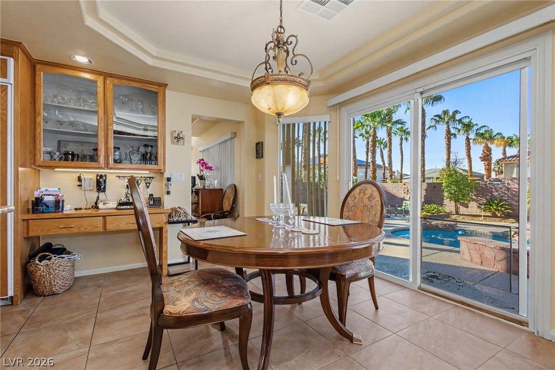 Sliding glass doors open from the dining space directly to the backyard pool patio.