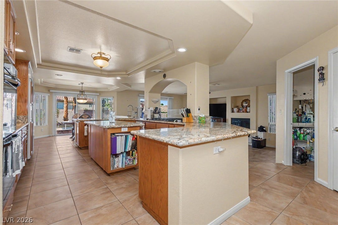 An open floorplan connects the expansive kitchen to comfortable living spaces beyond.