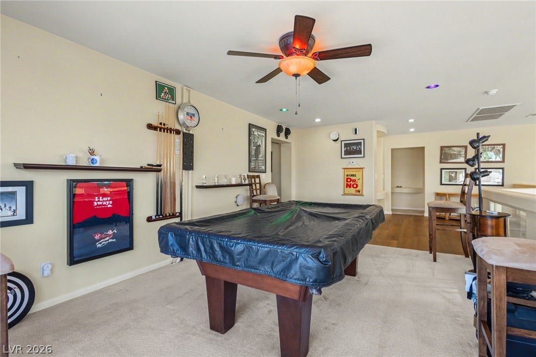 Recessed lighting and soft carpeting create a comfortable environment in this versatile basement recreation room.