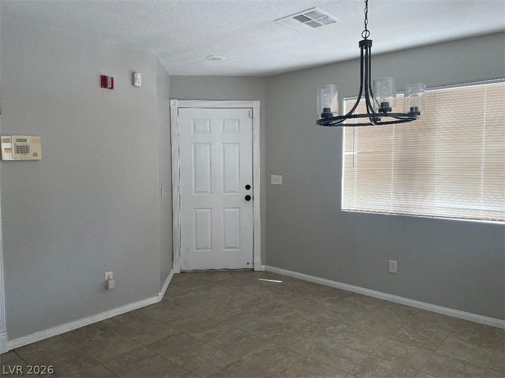 3025 Sunrise Bay Avenue, North Las Vegas, NV 89031 Tiled flooring and a modern light fixture welcome guests inside this open entry area.