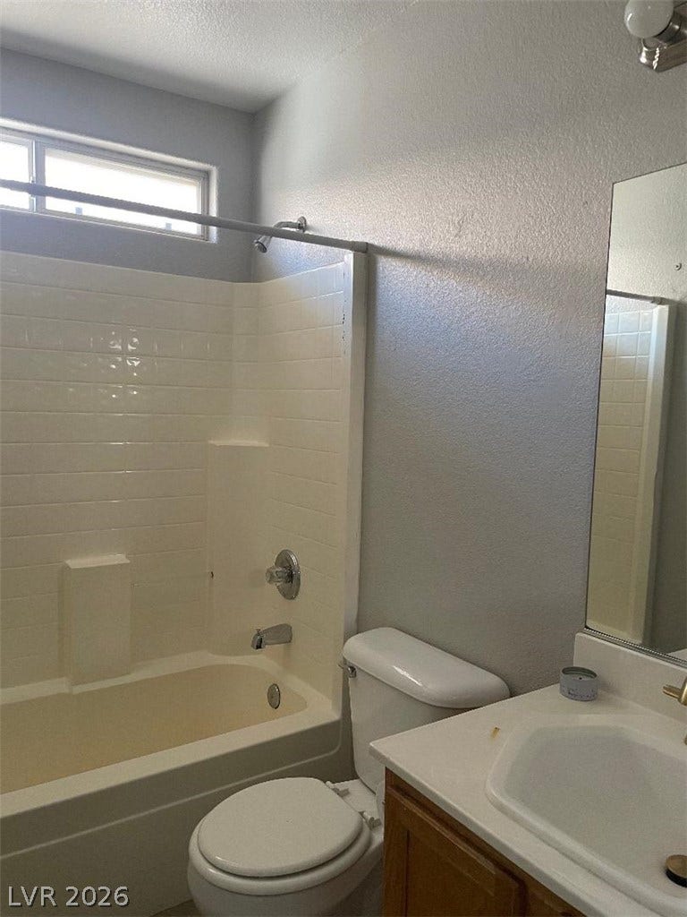 3025 Sunrise Bay Avenue, North Las Vegas, NV 89031 Tiled shower walls and a built-in bathtub frame this classic bathroom layout.