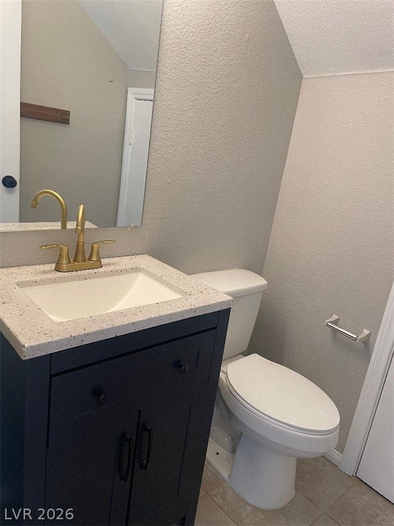3025 Sunrise Bay Avenue, North Las Vegas, NV 89031 A classic vanity with brushed brass hardware anchors this tidy half bath.