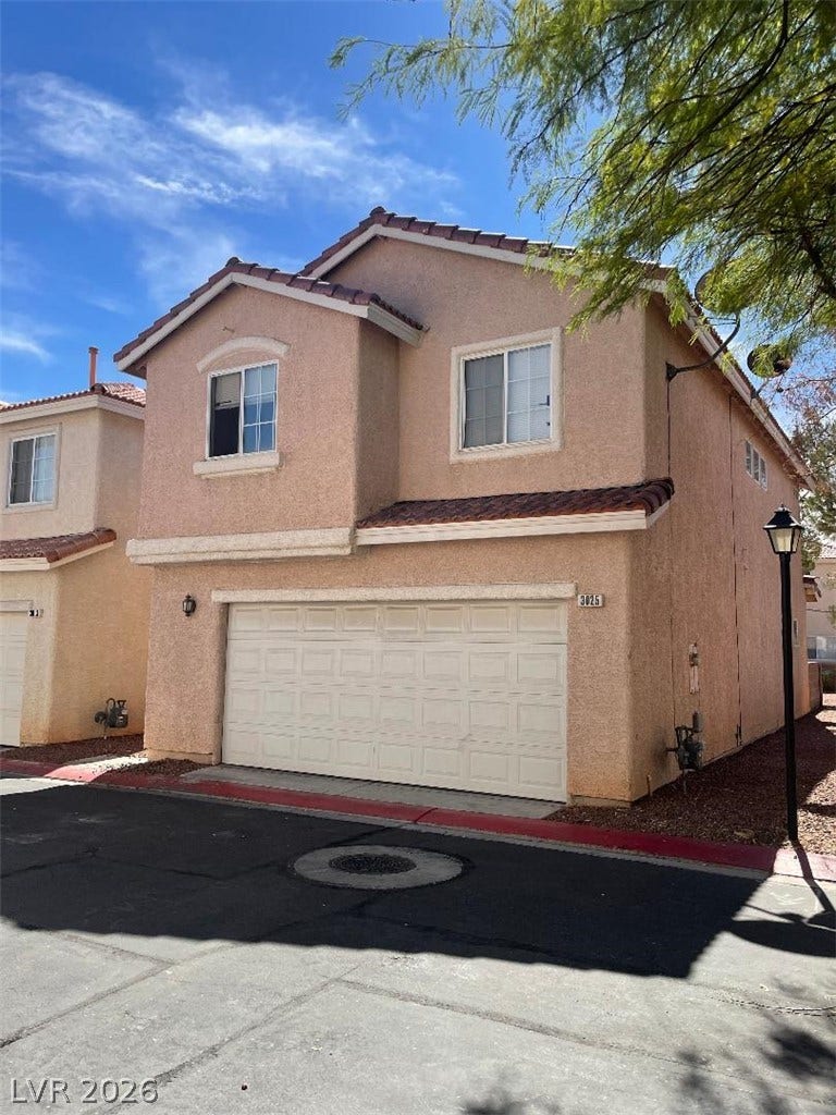 3025 Sunrise Bay Avenue, North Las Vegas, NV 89031 Stucco exterior finishes and tiled roofing create timeless appeal on this multi-level residential design.