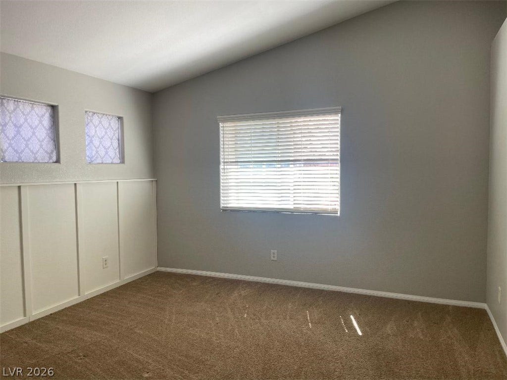 3025 Sunrise Bay Avenue, North Las Vegas, NV 89031 Vaulted ceilings and wood wainscoting bring architectural character to this versatile bedroom.