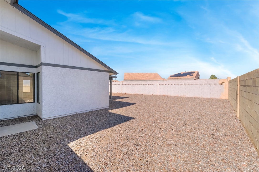 838 Anchor Drive, Henderson, NV 89015 An enclosed gravel yard offers low-maintenance outdoor space bordered by privacy block walls.