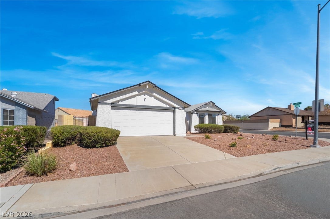 838 Anchor Drive, Henderson, NV 89015 A spacious driveway leads to the attached two-car garage of this classic suburban home.