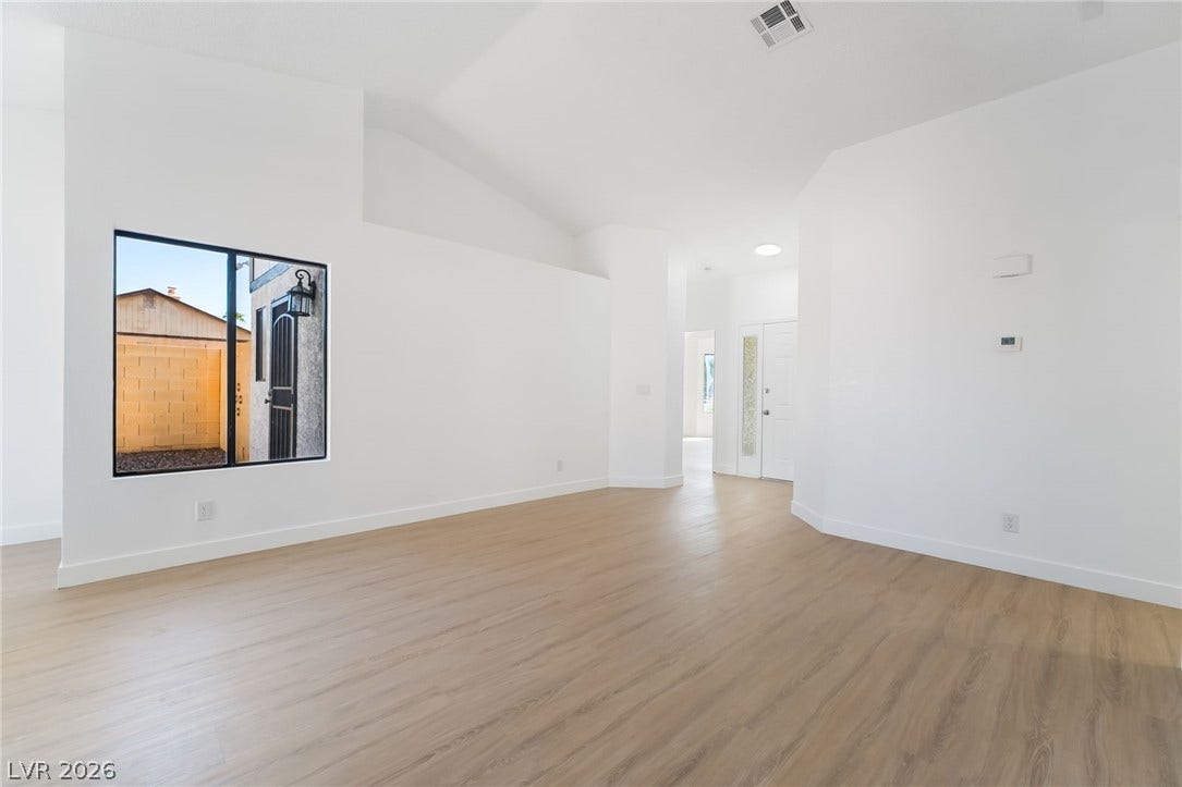 838 Anchor Drive, Henderson, NV 89015 Clean lines and warm wood-look flooring define this airy, light-filled living area.