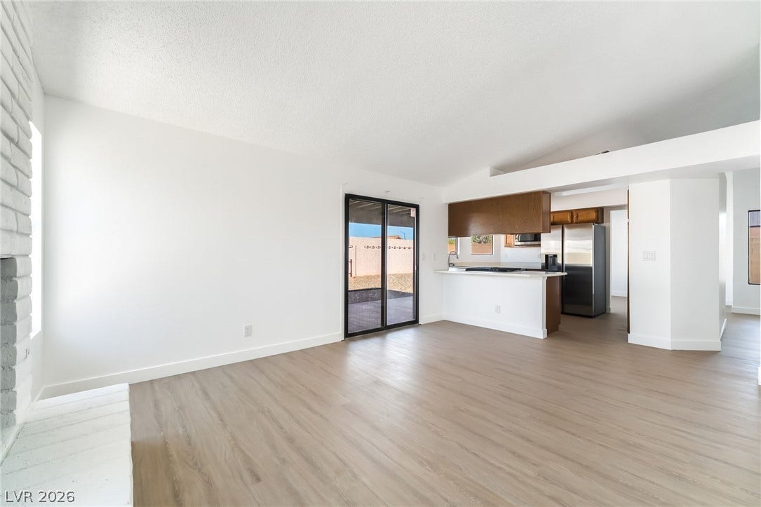 838 Anchor Drive, Henderson, NV 89015 An open living space transitions into the kitchen, anchored by smooth wood-style flooring.