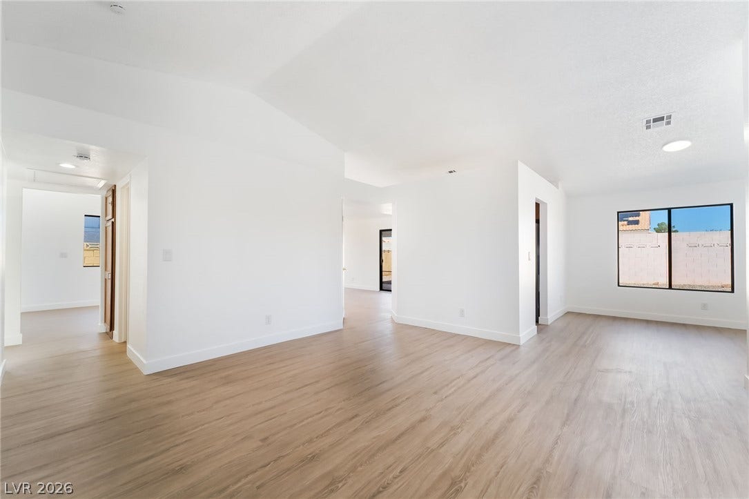 838 Anchor Drive, Henderson, NV 89015 An open floor plan connects versatile living spaces detailed with wood-textured floors.