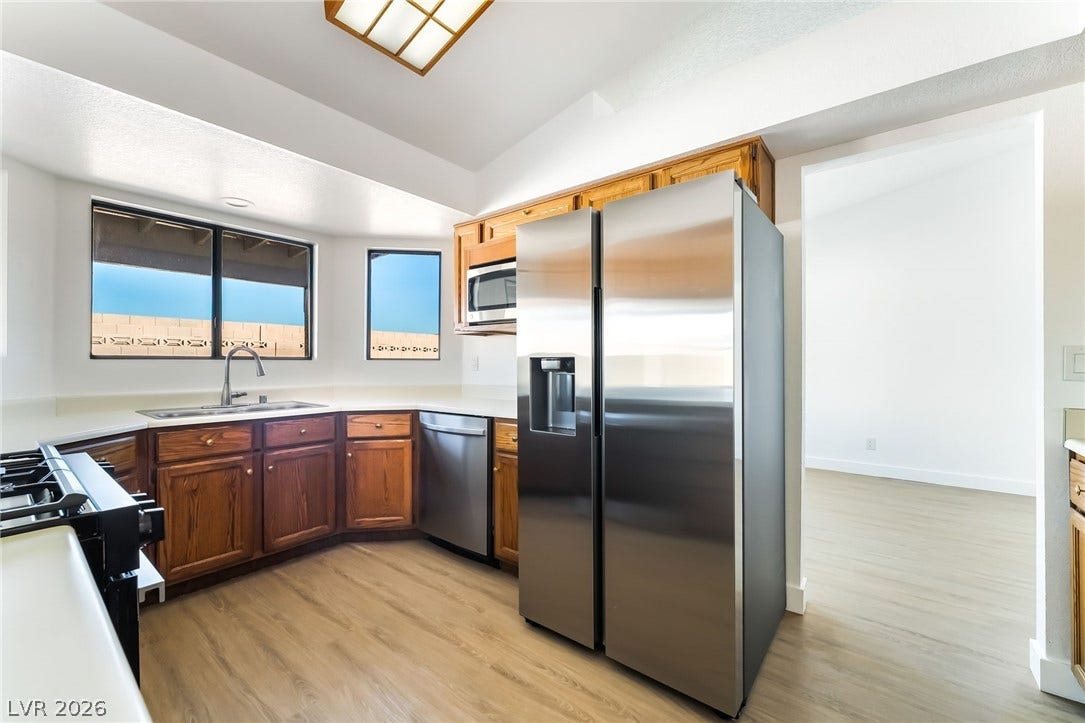 838 Anchor Drive, Henderson, NV 89015 Warm wood cabinetry and stainless steel appliances anchor this bright workspace.