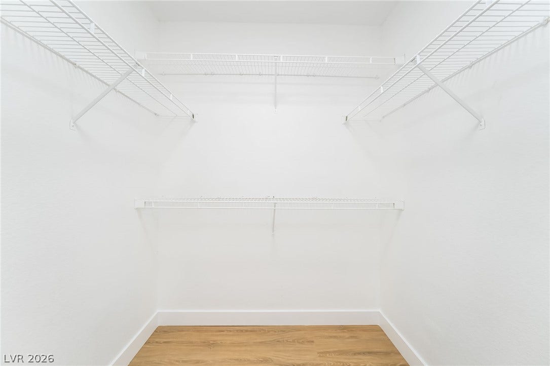 838 Anchor Drive, Henderson, NV 89015 A spacious walk-in closet boasts tiered wire shelving and smooth wood-style flooring.