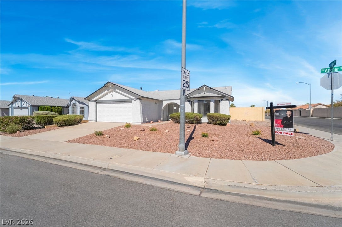 838 Anchor Drive, Henderson, NV 89015 Clean lines and a spacious driveway define this corner-lot residence under clear blue skies.