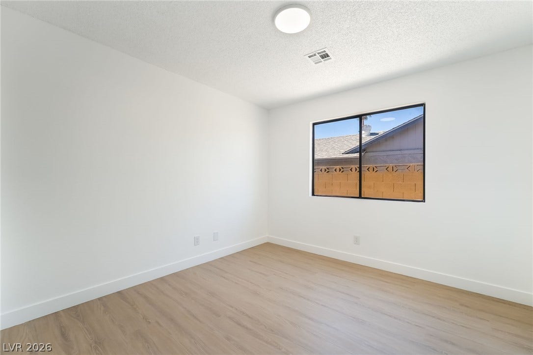838 Anchor Drive, Henderson, NV 89015 Clean lines and light wood flooring define this versatile secondary bedroom space.