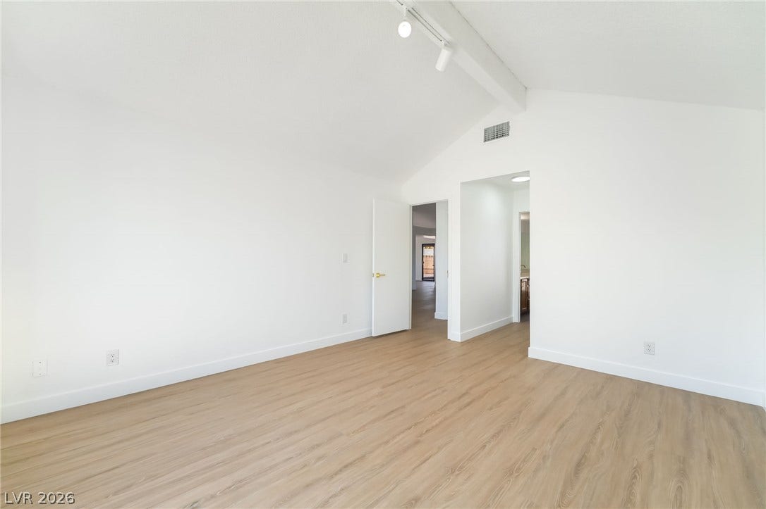 838 Anchor Drive, Henderson, NV 89015 Vaulted ceilings and wood-style flooring create an airy feel in this modern room.