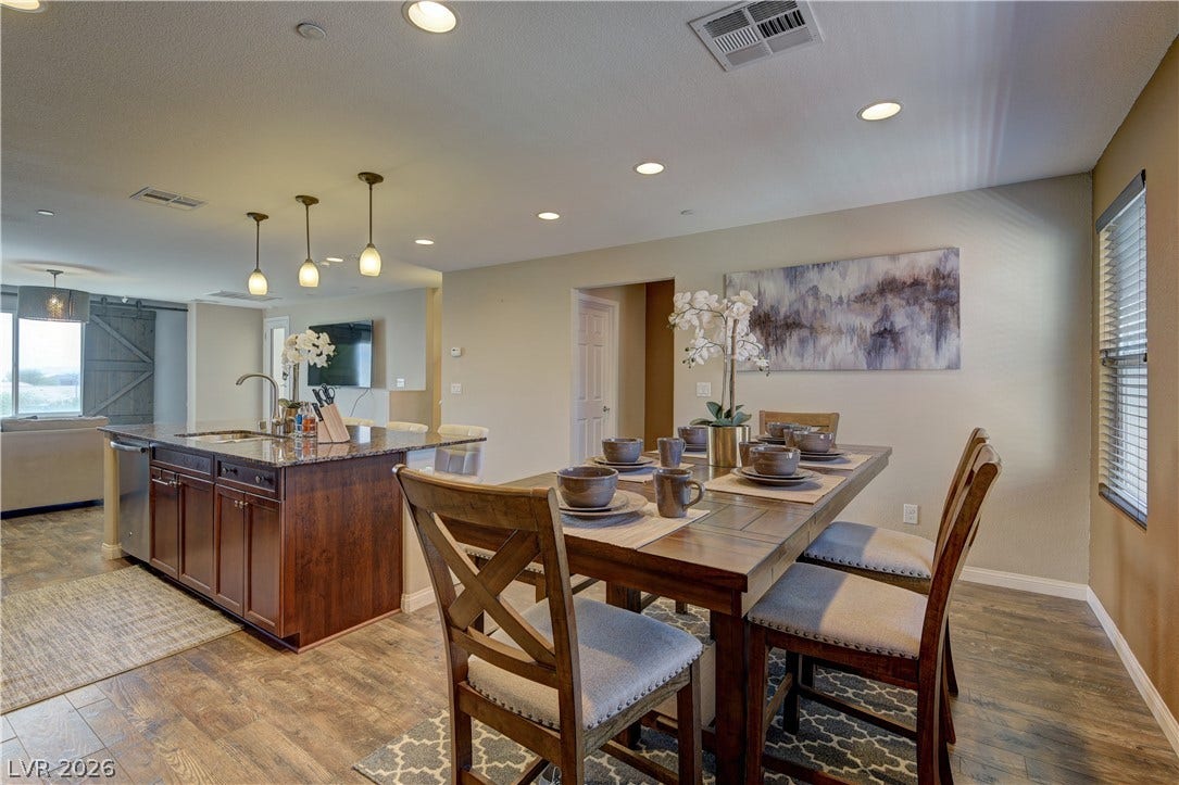 4650 Ranch House Road, #14, North Las Vegas, NV 89031 Gleaming wood-look floors anchor this open-concept dining area adjacent to the modern kitchen.