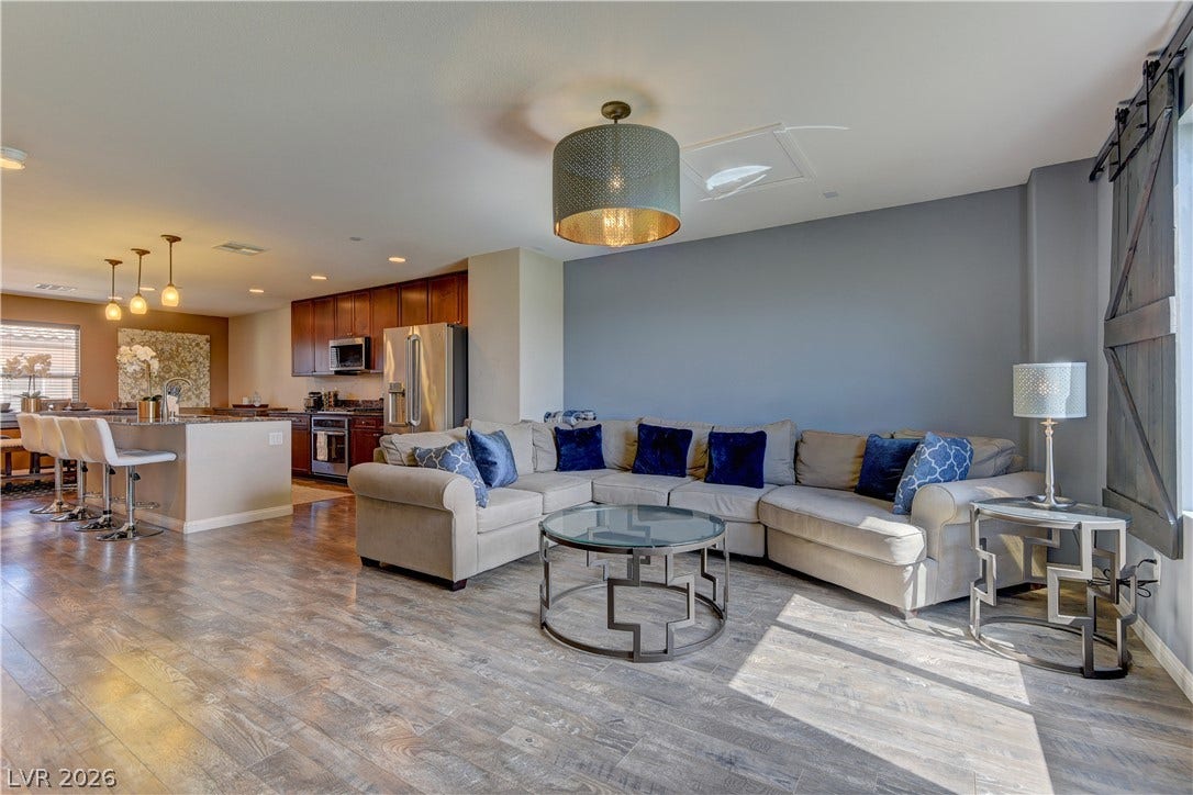 4650 Ranch House Road, #14, North Las Vegas, NV 89031 Gleaming wood-look floors anchor this airy, open-concept living area and modern kitchen.