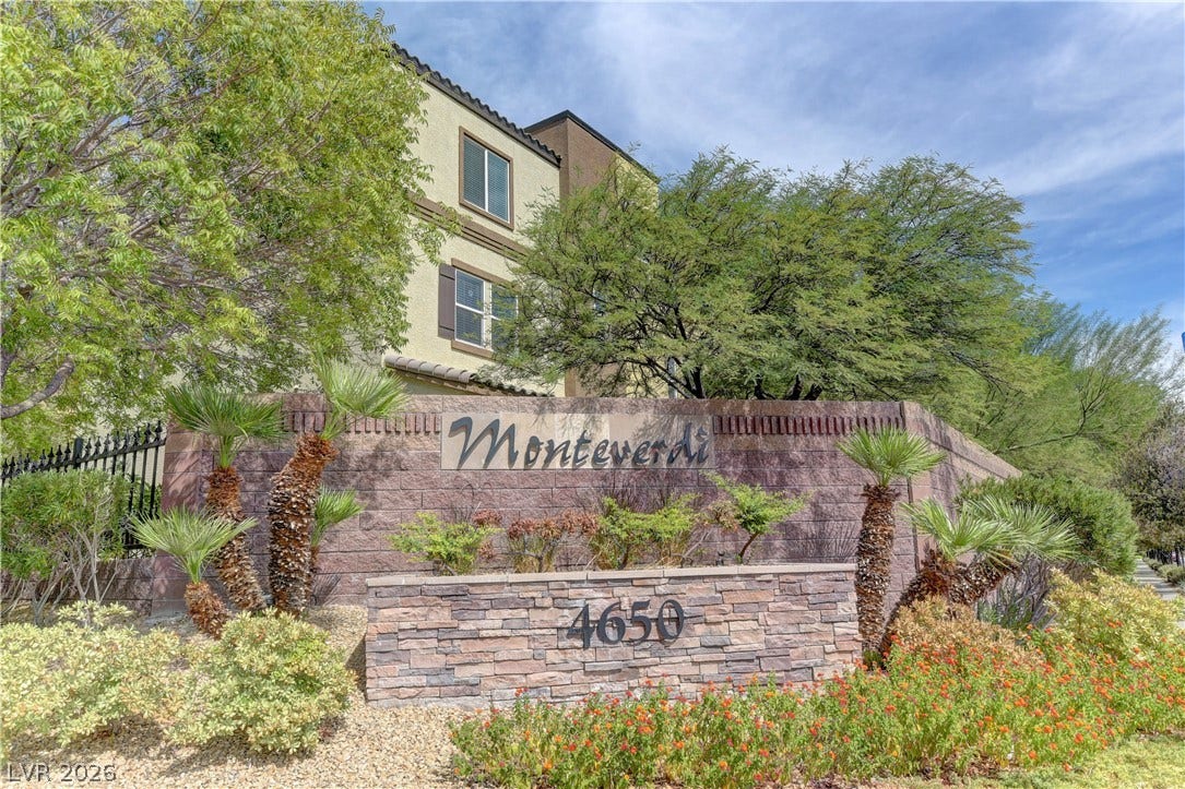 4650 Ranch House Road, #14, North Las Vegas, NV 89031 A stone monument sign and mature landscaping frame the entrance to this residential community.