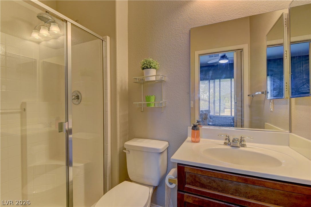 4650 Ranch House Road, #14, North Las Vegas, NV 89031 An integrated vanity with stone counters anchors this functional bathroom space.
