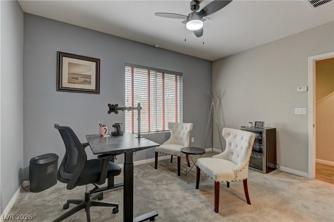 4650 Ranch House Road, #14, North Las Vegas, NV 89031 A spacious home workspace includes plush carpeting and a wide window with integrated blinds.