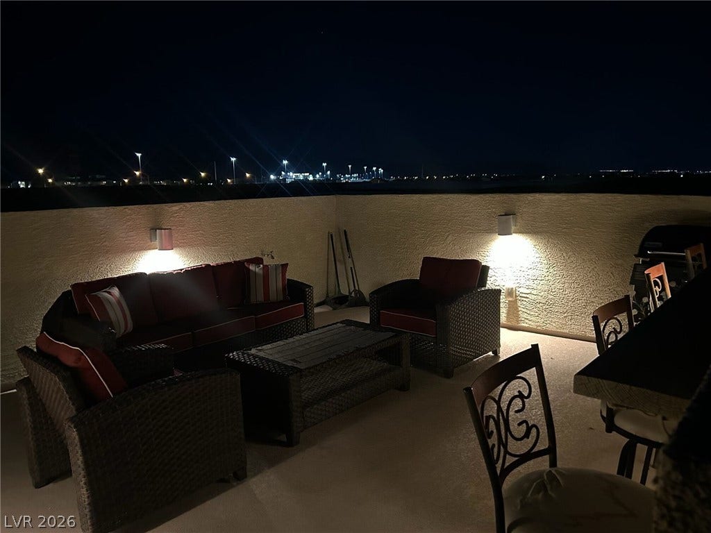 4650 Ranch House Road, #14, North Las Vegas, NV 89031 Distant city lights shimmer beyond the privacy walls of this expansive outdoor rooftop terrace.
