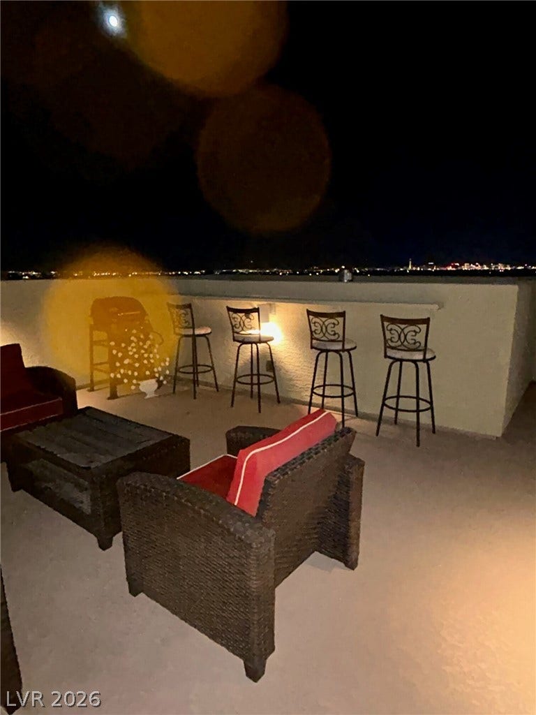 4650 Ranch House Road, #14, North Las Vegas, NV 89031 An elevated terrace overlooks sparkling distant city lights under the night sky.