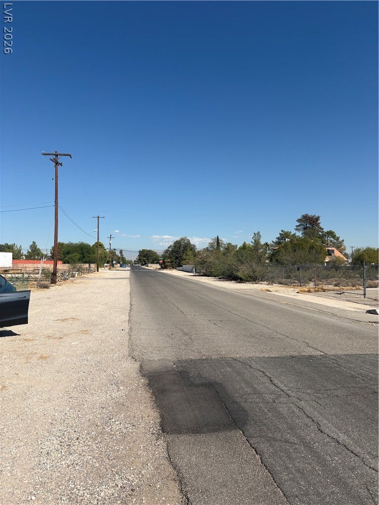 Duneville Street, Las Vegas, NV 89146 A paved street borders the property under a clear blue sky.