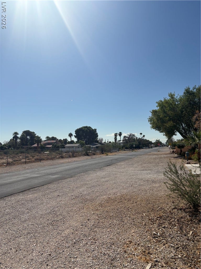 Duneville Street, Las Vegas, NV 89146 Quiet neighborhood streets wind through a peaceful suburban setting under clear blue skies.