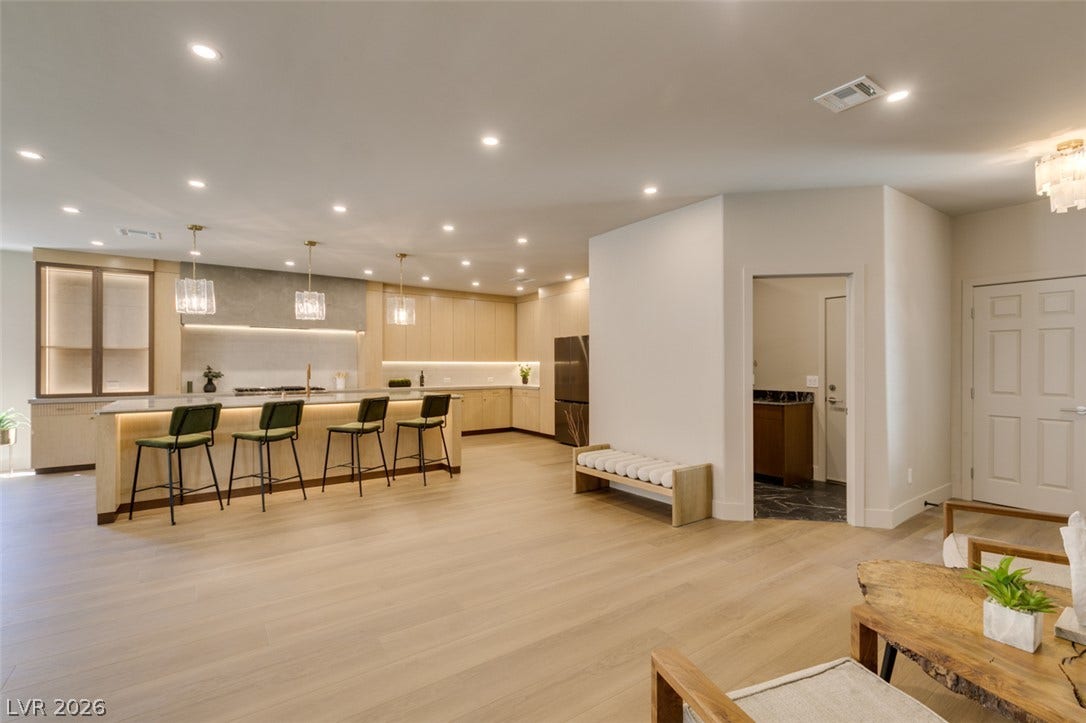 2897 Sunlit Glade Avenue, Henderson, NV 89074 An open floorplan seamlessly connects the spacious kitchen with the adjoining living area.