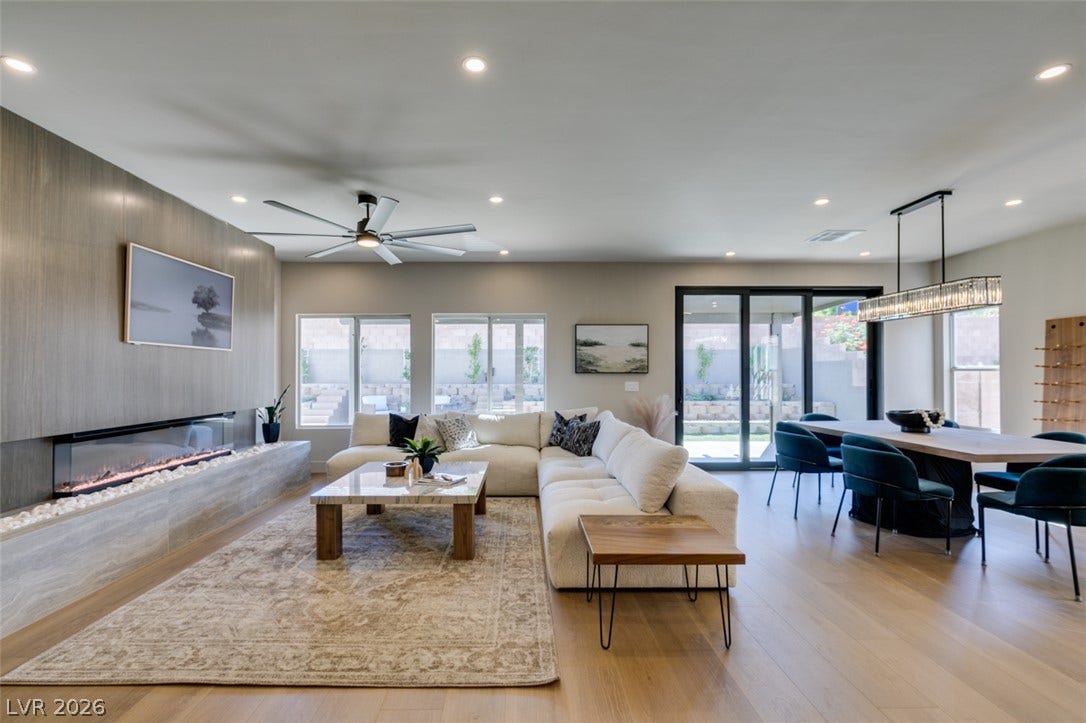 2897 Sunlit Glade Avenue, Henderson, NV 89074 An open floorplan seamlessly connects the airy living area to the adjacent dining zone.