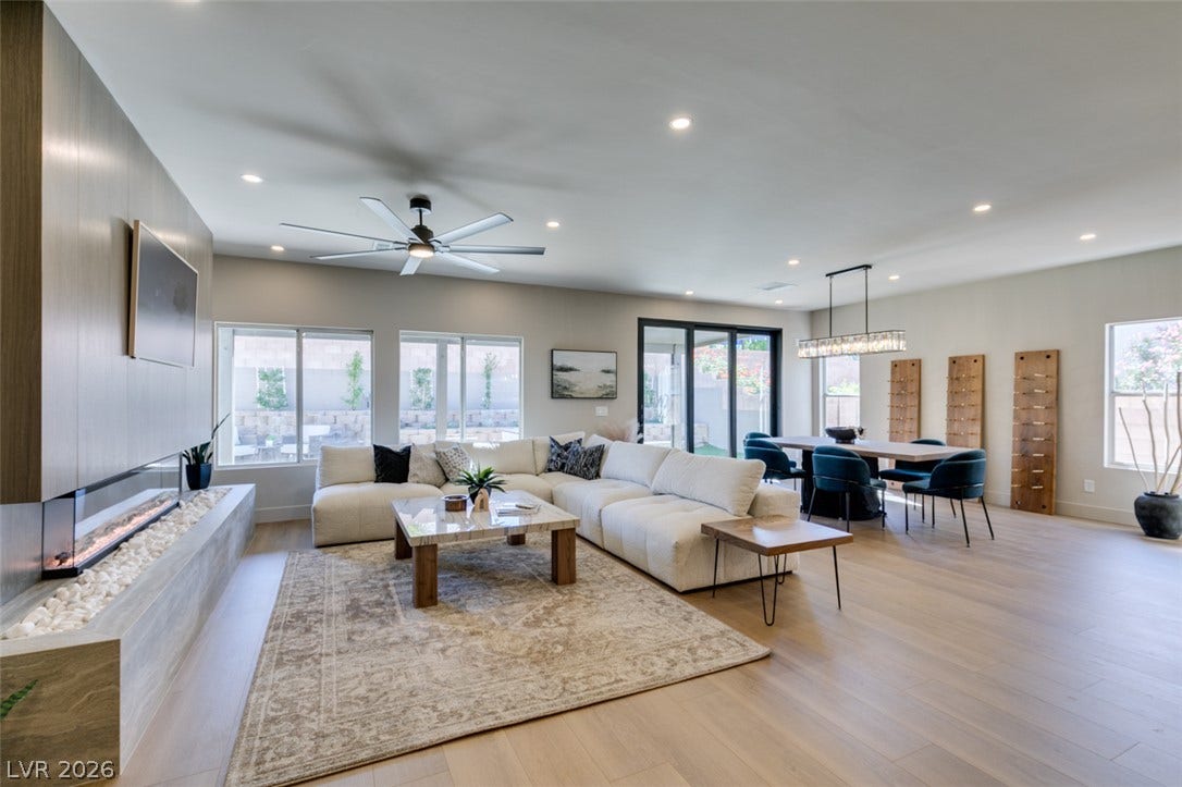 2897 Sunlit Glade Avenue, Henderson, NV 89074 An open floorplan seamlessly connects the bright living area to the adjacent dining space.