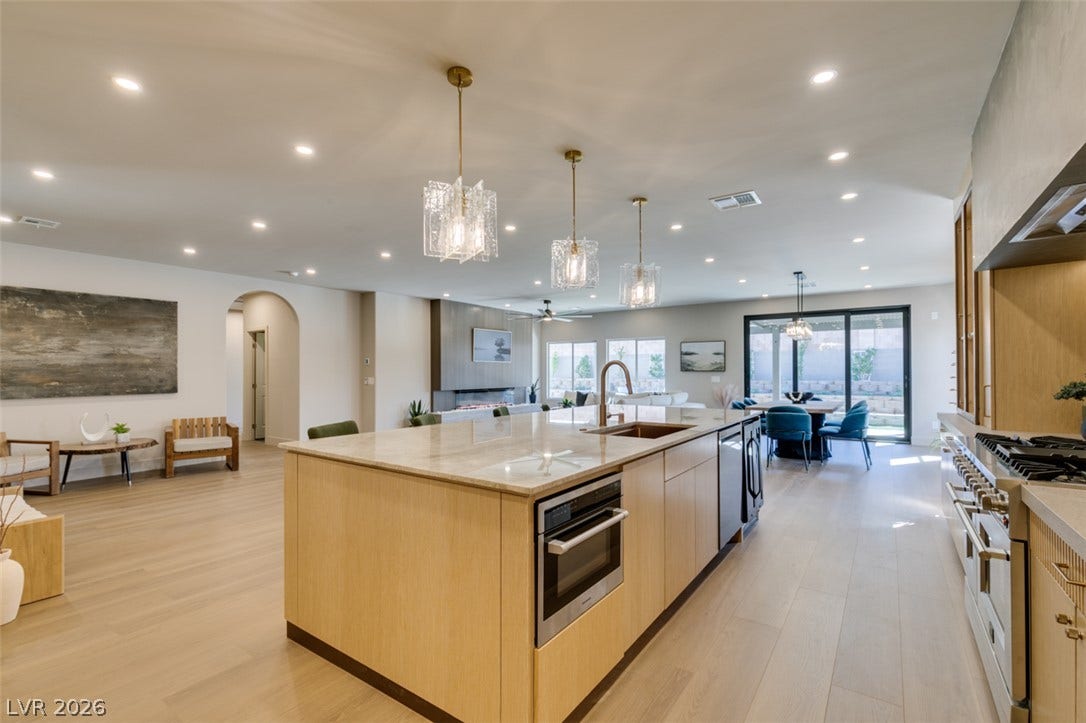2897 Sunlit Glade Avenue, Henderson, NV 89074 An expansive open floorplan connects the modern kitchen and living spaces seamlessly.