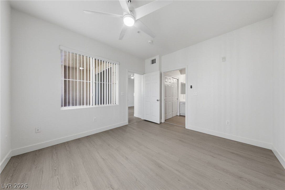 7139 S Durango Drive, #110, Las Vegas, NV 89113 Smooth wood-style flooring and neutral walls define this versatile bedroom with an attached bath.