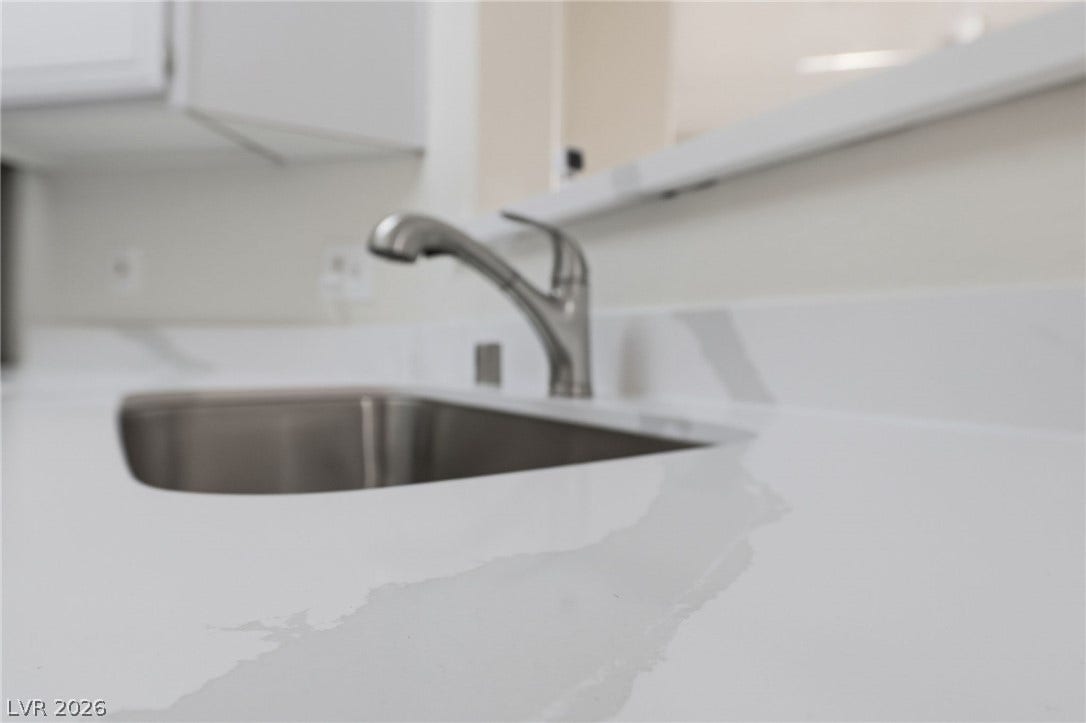 7139 S Durango Drive, #110, Las Vegas, NV 89113 Polished stone countertops pair seamlessly with a modern stainless steel under-mount sink.