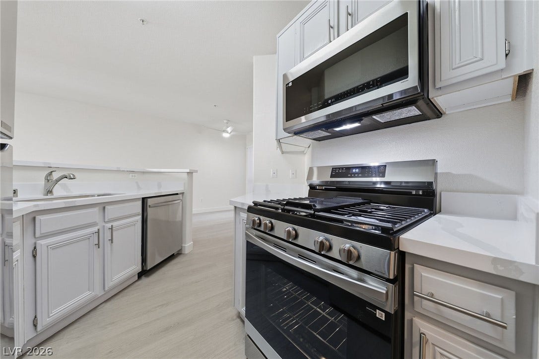 7139 S Durango Drive, #110, Las Vegas, NV 89113 Modern cabinetry and solid countertops anchor this functional cooking space.