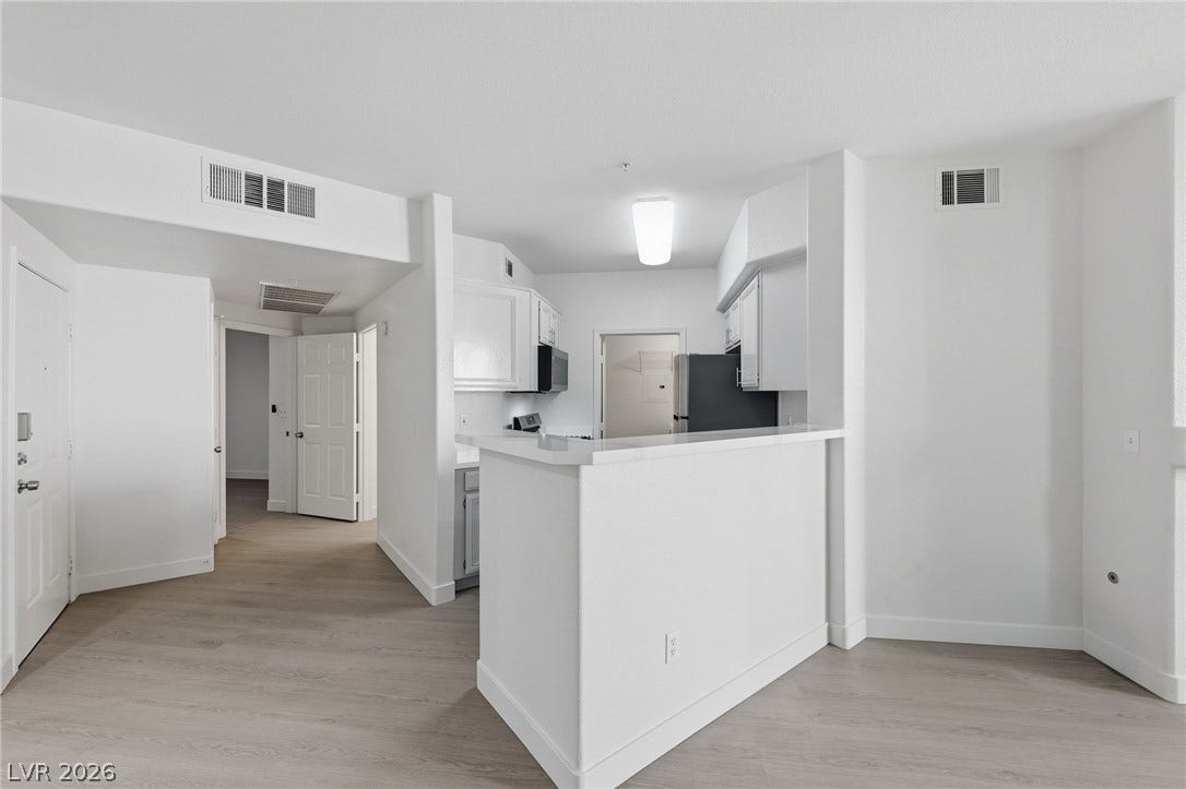 7139 S Durango Drive, #110, Las Vegas, NV 89113 Smooth wood-look flooring and an elevated breakfast bar define this open layout.