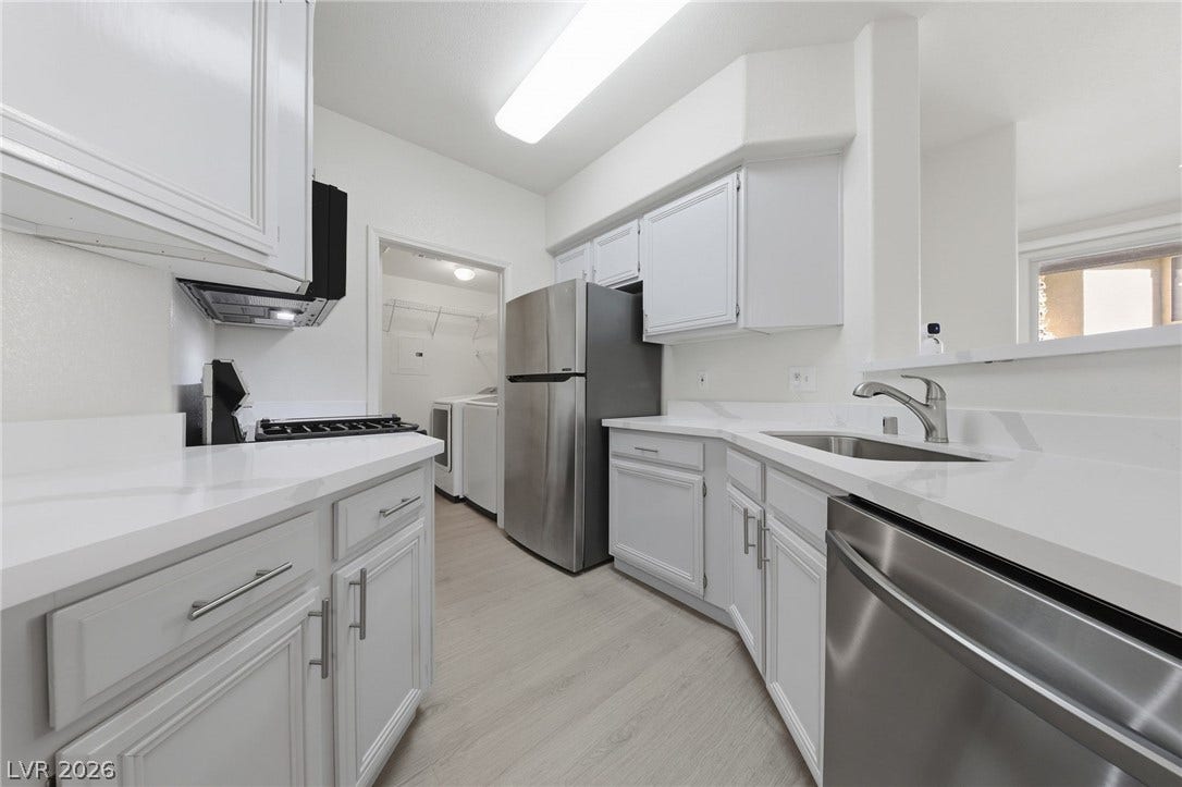 7139 S Durango Drive, #110, Las Vegas, NV 89113 Streamlined cabinetry and sleek solid-surface countertops define this modern kitchen workspace.