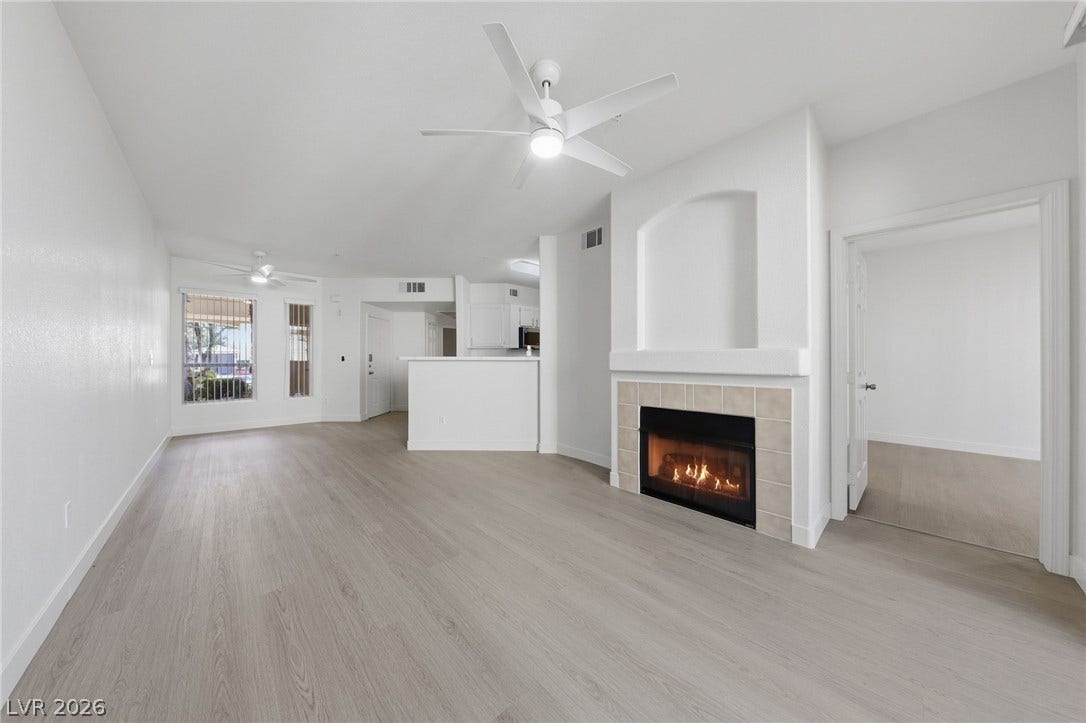 7139 S Durango Drive, #110, Las Vegas, NV 89113 An inviting fireplace serves as the centerpiece of this open living space with wood flooring.