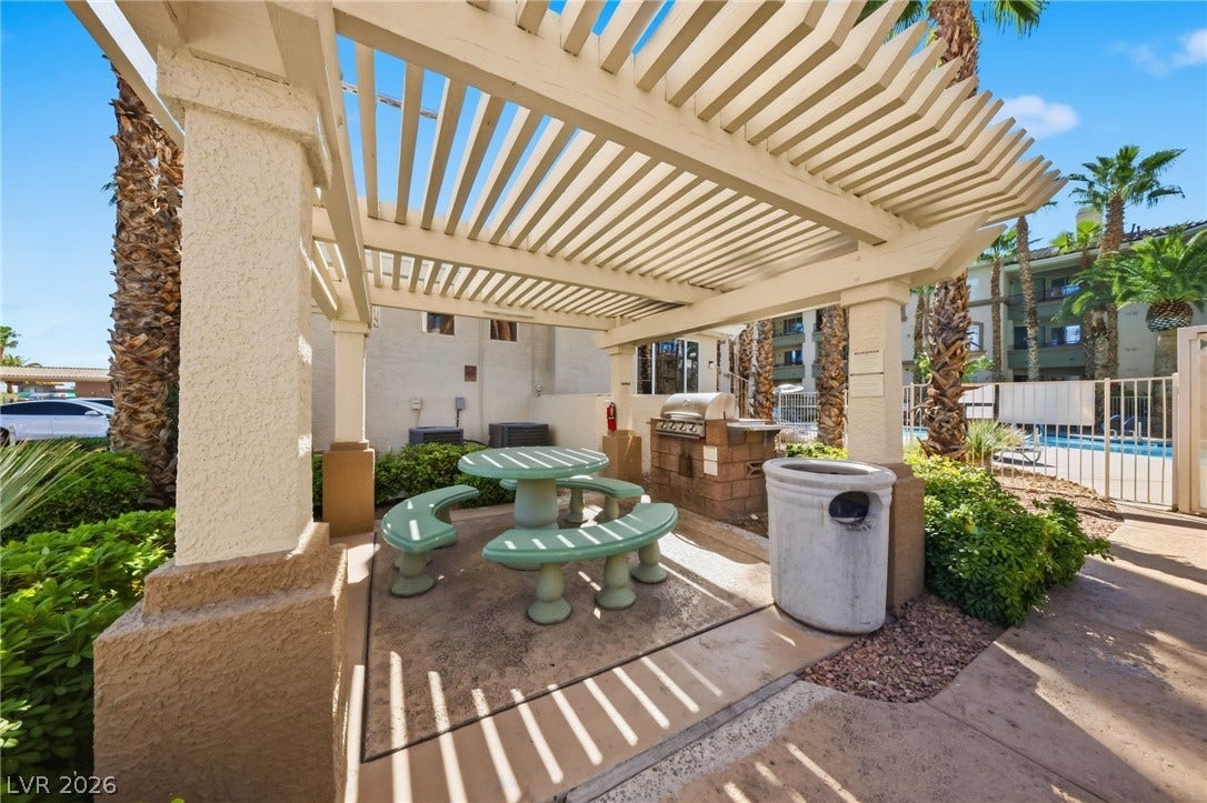 7139 S Durango Drive, #110, Las Vegas, NV 89113 A spacious outdoor pergola structures the common picnic space adjacent to the pool area.