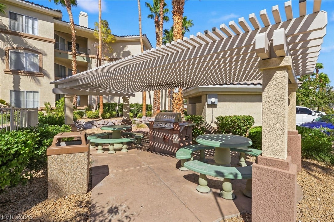 7139 S Durango Drive, #110, Las Vegas, NV 89113 A spacious outdoor picnic area features a large shaded pergola and built-in barbecue grill.